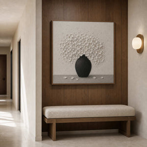 Textured white floral wall art displayed in a residential gallery hallway.