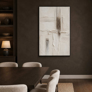 Neutral relief artwork creating contrast in a dark modern dining room.
