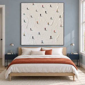 Square snow artwork above a bed with a rust-orange throw.
