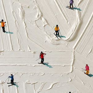 Detail of tiny red, yellow, and blue skiers among raised white ridges.