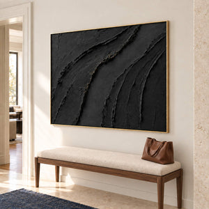 Sweeping raised black ridges with subtle gold accents in a gold frame, displayed above an entryway console.