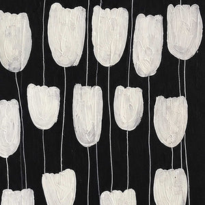 Close view of ridged white flower petals and slender stems against black.