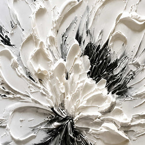 Close detail of raised white petal folds surrounding the dark flower center.