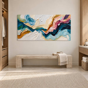 Textured multicolor painting above a pale bench beside light wood dressing-room cabinetry.