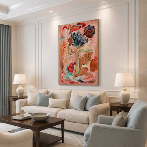 Silver framed floral painting above a cream sofa with pale blue cushions.