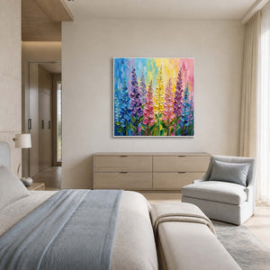 Pastel floral painting styled in a calm gray-blue bedroom sitting area.
