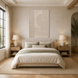 White framed beige geometric relief above a cream bed with muted green accents.
