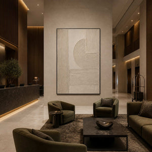 Black framed curved relief panel beside a hotel reception desk and lounge seating.
