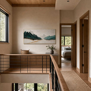 Textured mountain wall art displayed along a bright upper residential hallway.