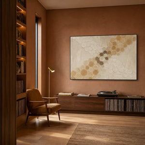 Golden circles crossing an ivory field wall art in a contemporary home office.