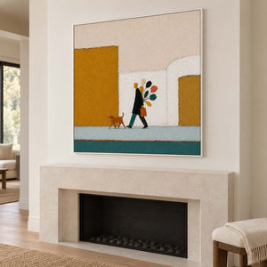 A figure walking a dog past mustard buildings with a colorful bouquet in a white frame, displayed above a fireplace.