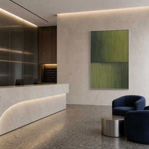 Minimalist green wall art in a refined hotel reception area.