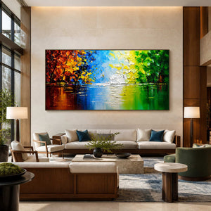 Black-framed colorful lake painting above a long cream sofa in a hotel lobby.
