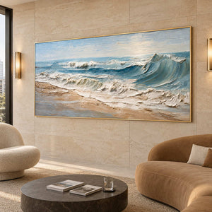 Wide sea and sand artwork on a beige tiled wall above a curved tan sofa.
