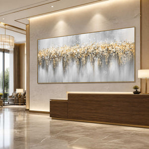 Gold framed panoramic abstract painting above a wooden reception desk in a hotel lobby.
