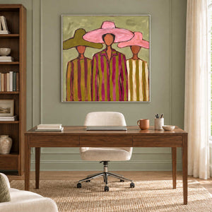 A Meeting in Style in a silver frame above a slim wood desk and cream office chair against sage paneling.