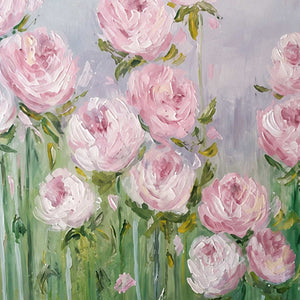 Close detail of raised pink and white petals above layered green stems and leaves.