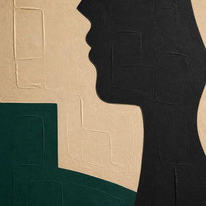 Close-up of black profile relief, ivory texture, and deep green paint.