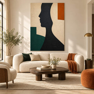 Hand-painted black profile canvas with ivory, green, and orange forms, displayed in a living room without an outer frame.