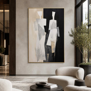 Gold framed painting of two figures beside curved chairs in a hotel lounge.