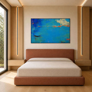 Vivid blue abstract canvas displayed above a warm modern bed.