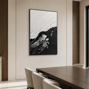 Black framed tidal abstraction beside a walnut dining table and cream upholstered chairs.