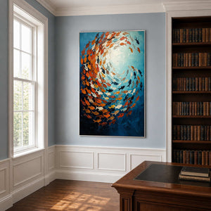Silver framed fish painting beside a wooden desk and bookshelves in a light blue office.