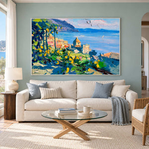 Coastal garden painting above a cream sofa and glass table.