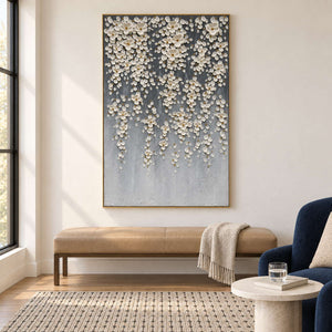 Gray floral artwork above a tan bench beside a blue armchair.