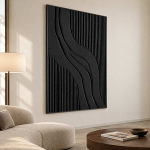 Tall black curves beside a rounded cream sofa and low brown coffee table.