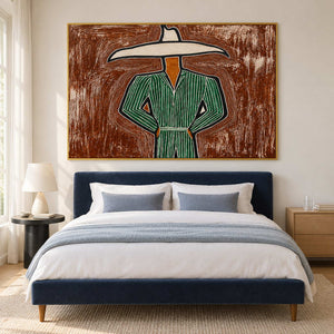 Green outfit painting above a navy bed with blue-gray bedding.
