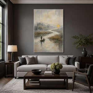 Misty river artwork displayed above a charcoal modern living room sofa.