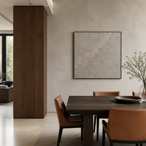 Neutral relief artwork displayed in a mineral-gray walnut dining room.