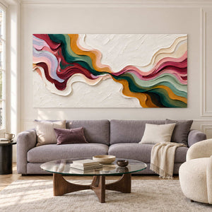Diagonal color-flow painting over a gray sofa and glass coffee table.