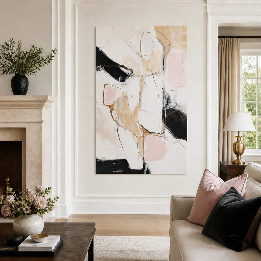 Frameless blush and black abstract artwork beside a fireplace and neutral sofa.