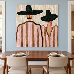 Pink-striped pair artwork above a wooden dining table with cream upholstered chairs.