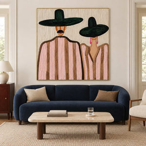 Paired-figure portrait above a navy sofa and a pale rectangular coffee table.