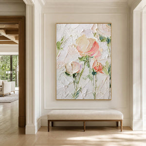 Gold framed pink flowers above an upholstered bench in a sunlit paneled hallway.