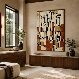 Wood framed cream and rust abstract painting beside a vanity in a bathroom dry area.