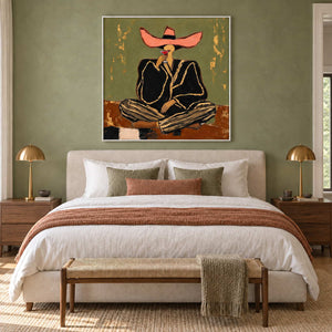 A Toast to Freedom in a white frame above a cream bed with a rust throw against a sage wall.