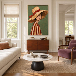 Ribboned-hat portrait above a brown cabinet between a cream sofa and plum armchair.