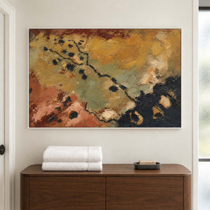 Weathered ochre, moss green and rust tones crossed by dark marks in a white frame, displayed in a bathroom dry area.