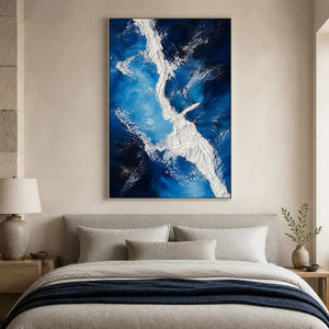 Cobalt and ivory textured canvas above a serene neutral bed.
