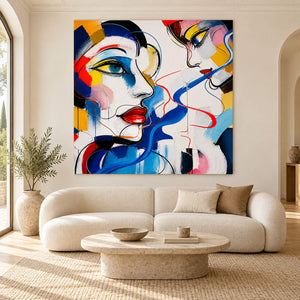 Hand-painted square portrait canvas with expressive faces and vivid color, displayed in a living room without an outer frame.