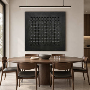 Raised black grid painting above a round wood dining table with dark-seat chairs.