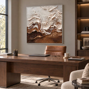 At Ease in a silver frame above a dark wood desk and tan leather office chair.