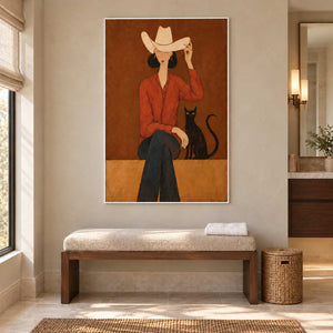 At Leisure in a white frame above a cushioned bench with folded towels in a bathroom dry area.