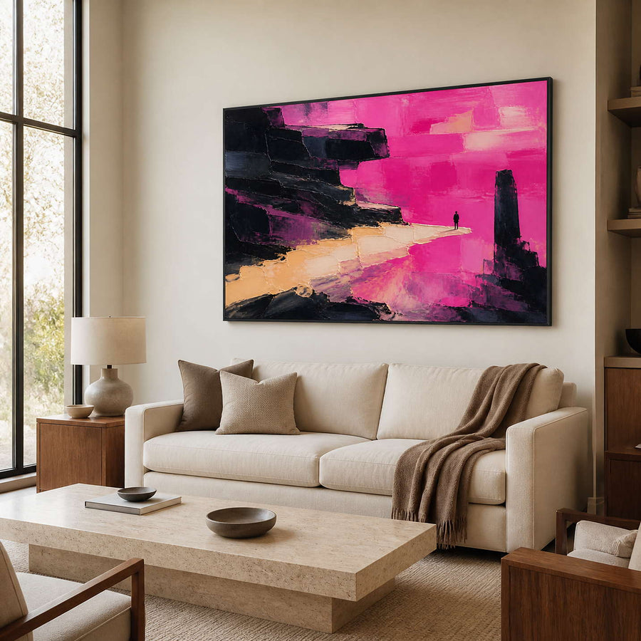 Pink and black abstract wall art above a warm modern living room sofa.