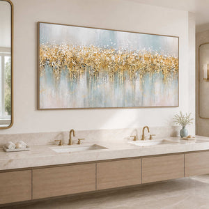 Wood framed blue gray and gold artwork above a double vanity in a bright bathroom.