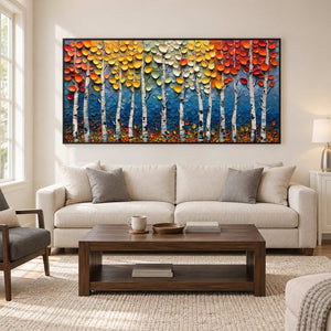 Colorful woodland painting above a cream sofa and dark wood table.